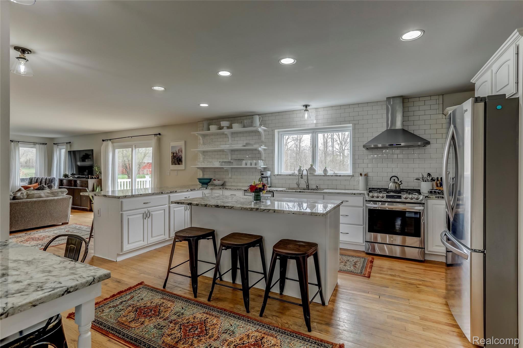 2695 Chilson Road Howell, MI 48843 - Photo 15 of 50 Hardwood floors, granite countertops, and stainless steel appliances