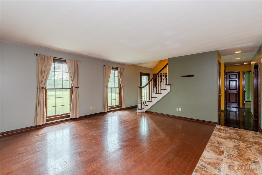 9981 Ridge Acres Lane Englewood, OH 45322 - Photo 7 of 73 This spacious living area features elegant hardwood floors and abundant natural light.