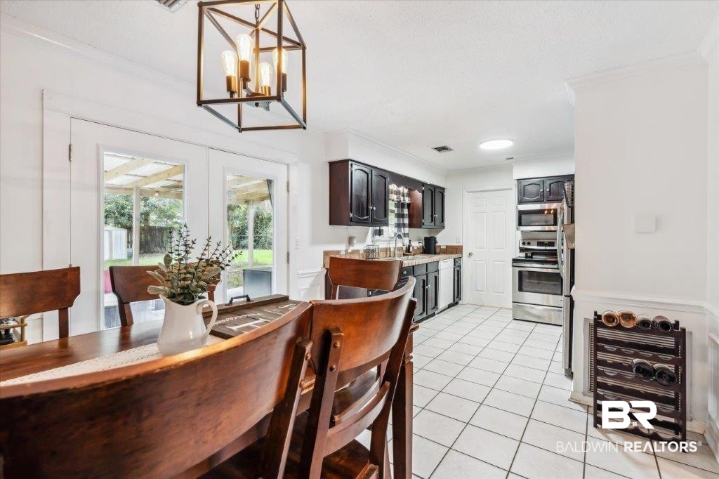 3616 Vista Ridge Drive Mobile, AL 36693 - Photo 9 of 20 Tiled dining room with wine cooler, ornamental molding, and a chandelier