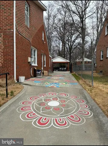 an empty room with wooden floor fireplace and fan