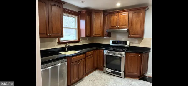 a view of a chandelier fan and wooden floor