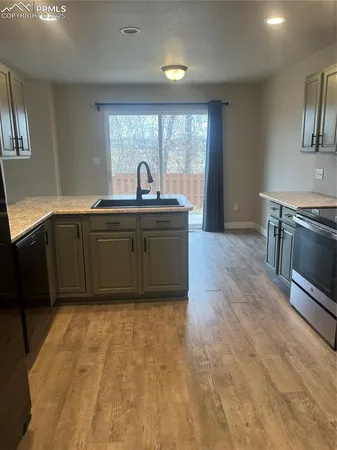 a kitchen with stainless steel appliances granite countertop a sink and a stove