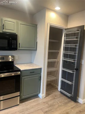 a stove top oven sitting inside of a kitchen