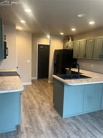 a kitchen with stainless steel appliances granite countertop a sink a stove and a refrigerator