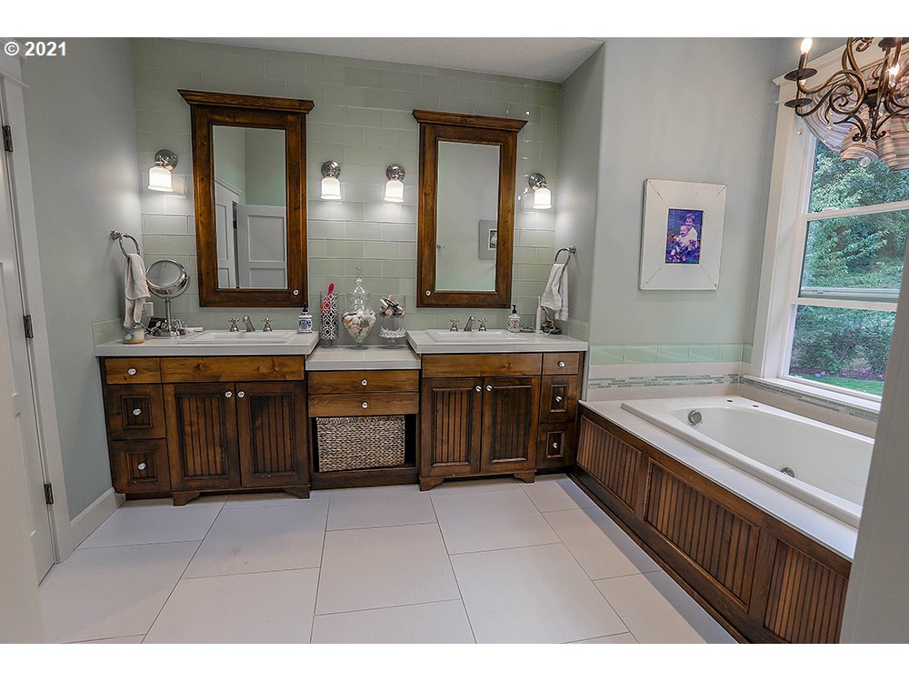 531 South 19th Place Ridgefield, WA 98642 - Photo 15 of 32 a spacious bathroom with a granite countertop double vanity sink a mirror a bathtub and window