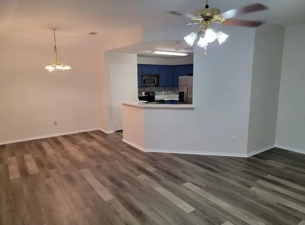a view of a kitchen with a sink cabinets and wooden floor