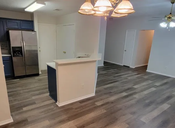 a kitchen with a refrigerator sink and cabinets
