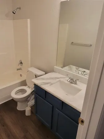 a bathroom with a sink a toilet and bathtub