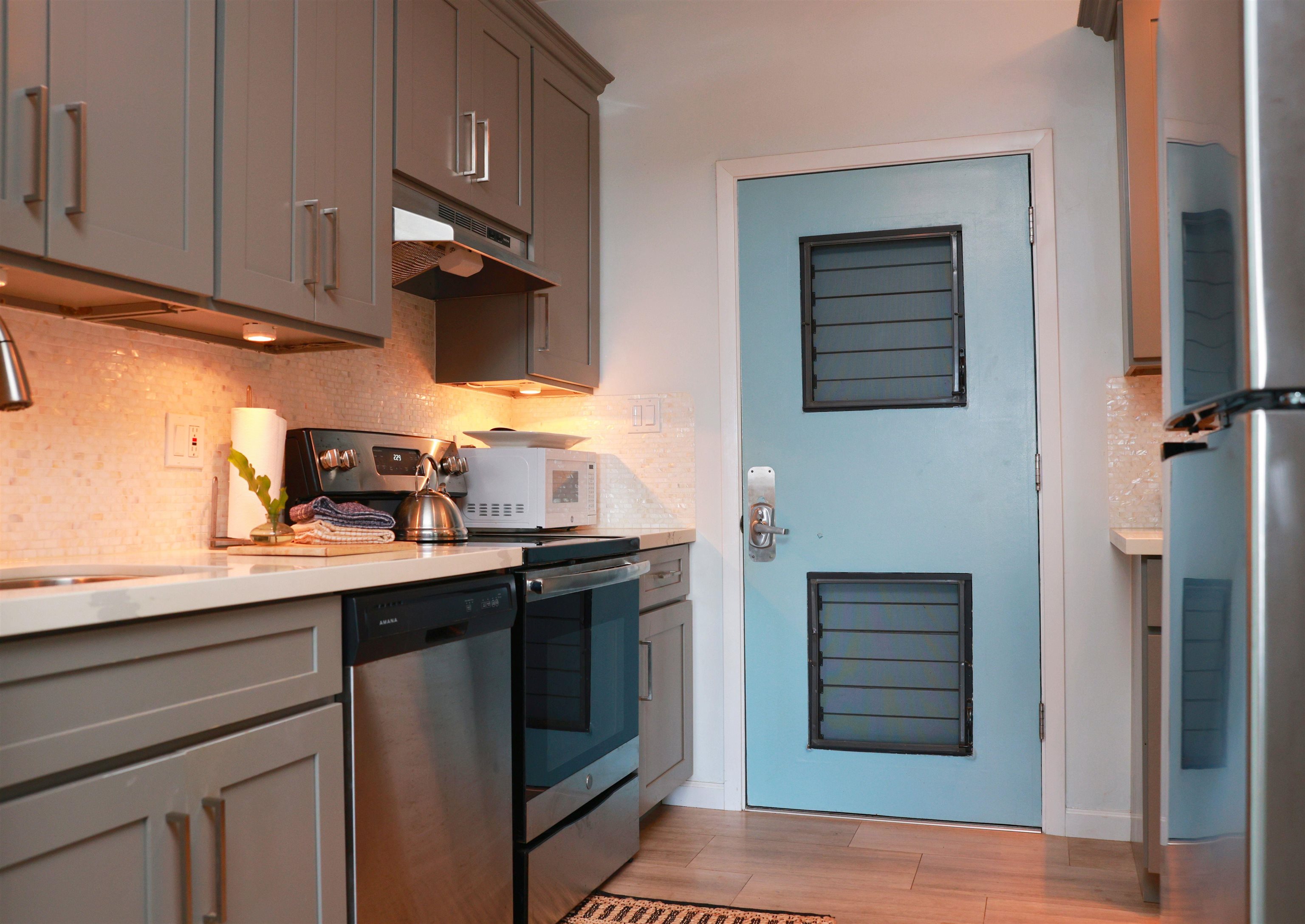 4435 Lower Honoapiilani Road, Unit 205 Lahaina, HI 96761 - Photo 11 of 26 a kitchen with stainless steel appliances granite countertop a sink stove and cabinets