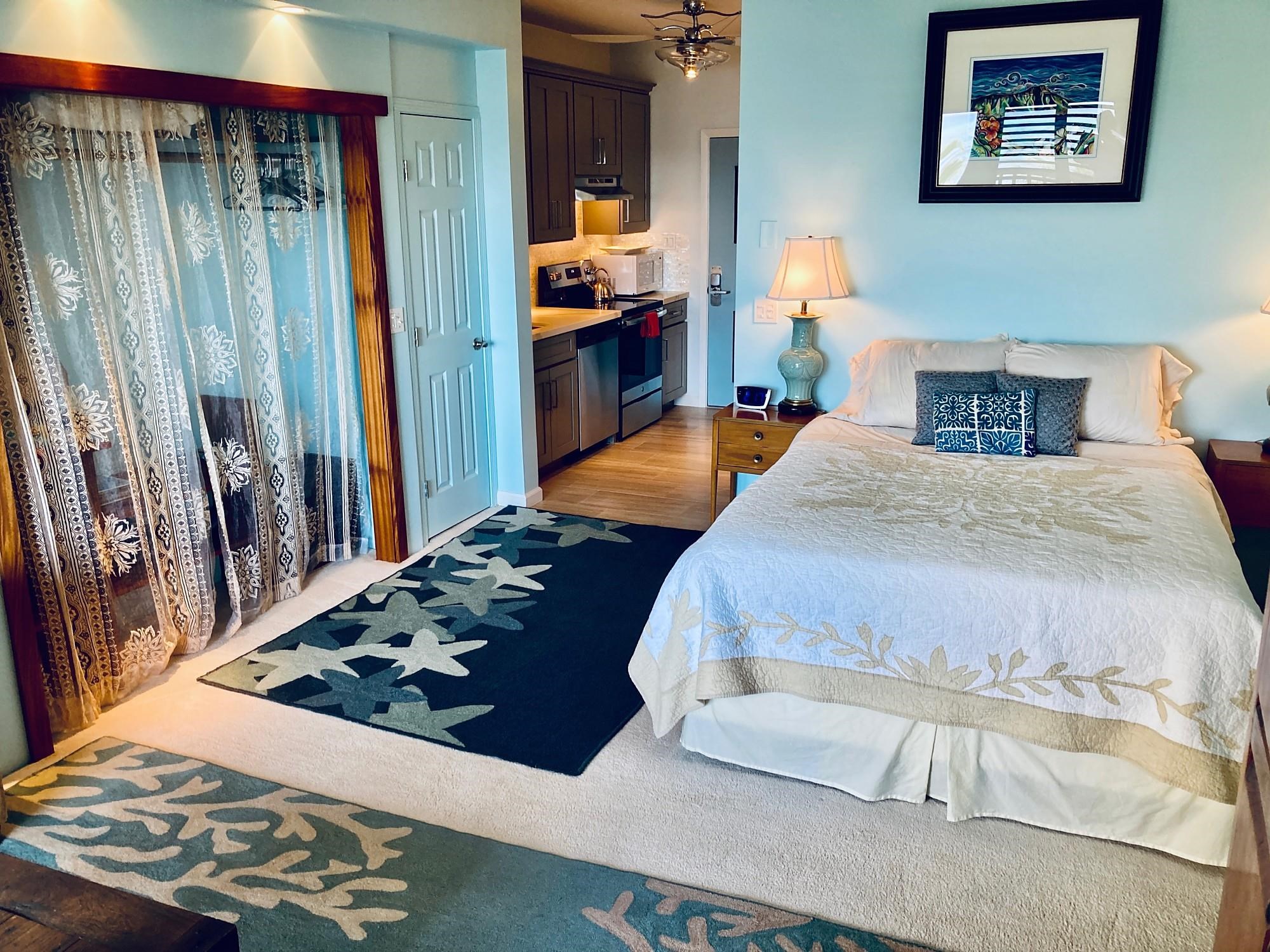 4435 Lower Honoapiilani Road, Unit 205 Lahaina, HI 96761 - Photo 15 of 26 a bedroom with a bed and a dresser with wooden floor