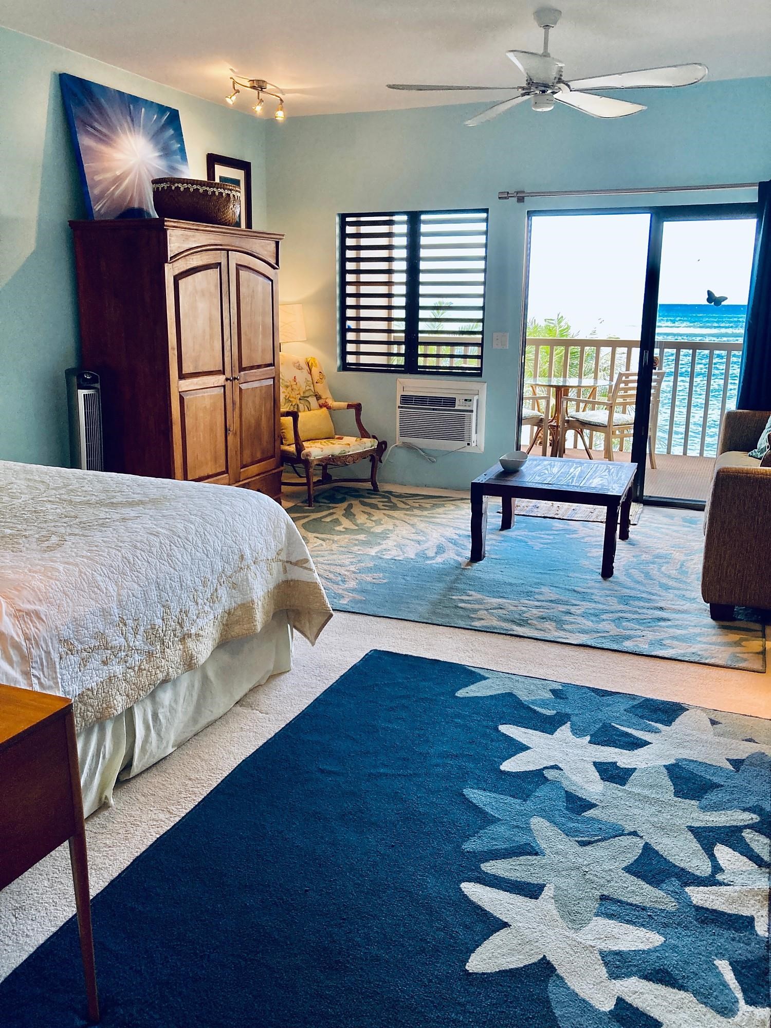 4435 Lower Honoapiilani Road, Unit 205 Lahaina, HI 96761 - Photo 16 of 26 a bedroom with a bed and wooden floor