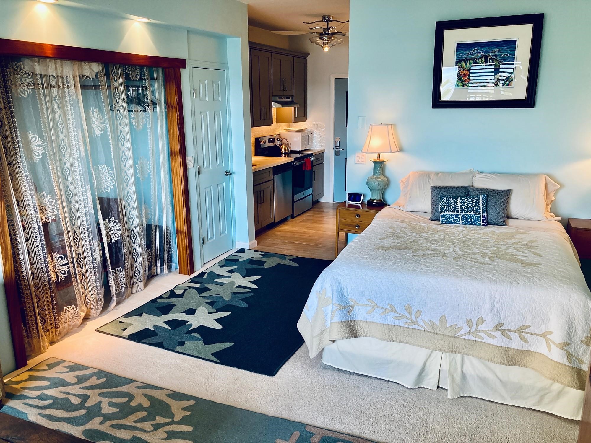 4435 Lower Honoapiilani Road, Unit 205 Lahaina, HI 96761 - Photo 17 of 26 a bedroom with a bed and a large mirror on the dresser