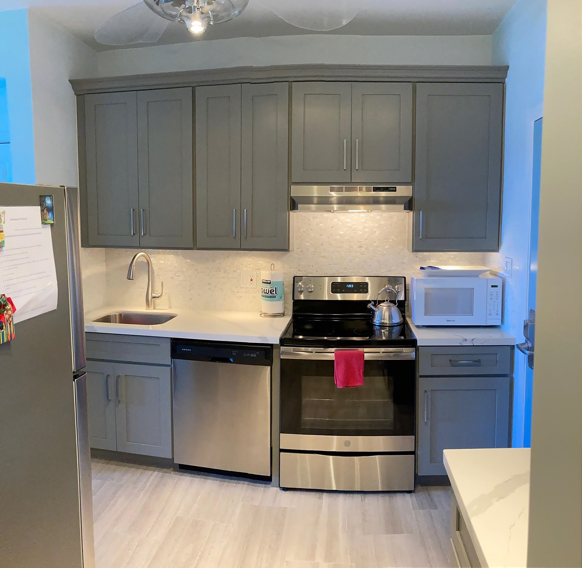 4435 Lower Honoapiilani Road, Unit 205 Lahaina, HI 96761 - Photo 5 of 26 a kitchen with a stove and a refrigerator