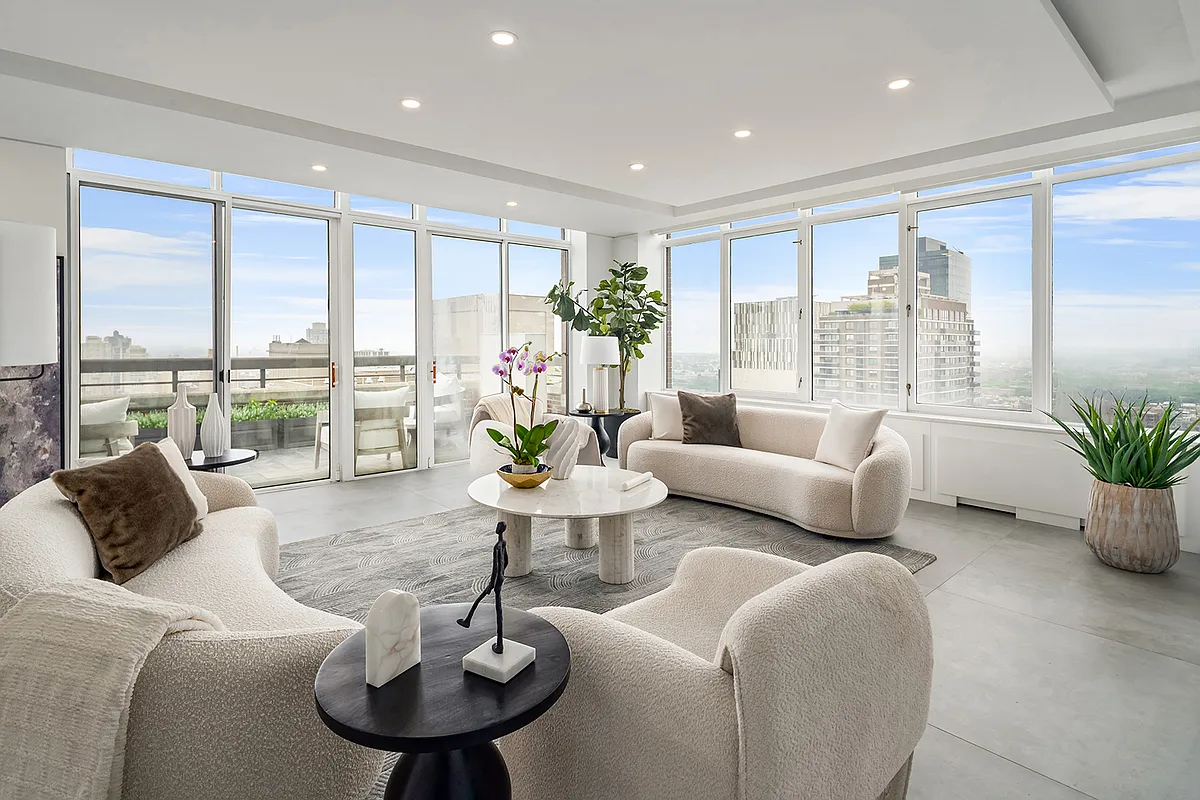 422 East 72nd Street, Unit 37AD Manhattan, NY 10021 - Photo 1 of 58 a living room with furniture potted plant and a large window