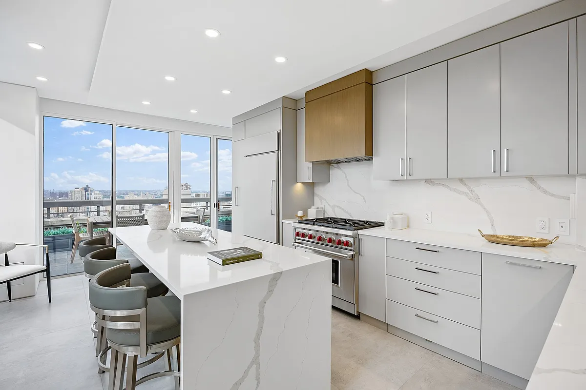 422 East 72nd Street, Unit 37AD Manhattan, NY 10021 - Photo 15 of 58 a kitchen with a stove a sink a dining table and chairs