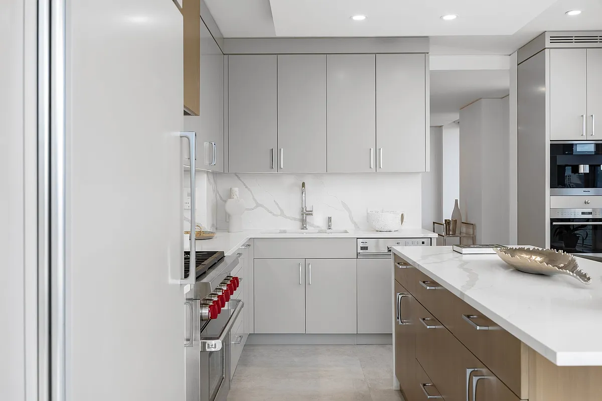 422 East 72nd Street, Unit 37AD Manhattan, NY 10021 - Photo 18 of 58 a utility room with cabinets washer and dryer