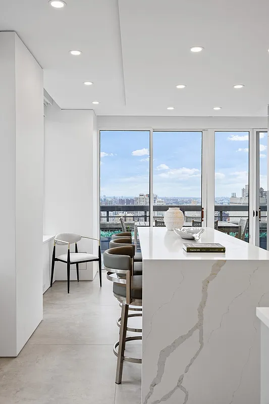 422 East 72nd Street, Unit 37AD Manhattan, NY 10021 - Photo 21 of 58 a dining room with a large window and table