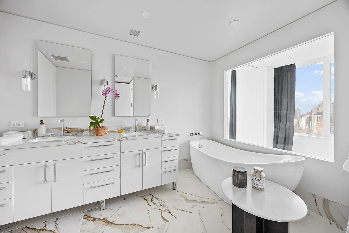 422 East 72nd Street, Unit 37AD Manhattan, NY 10021 - Photo 28 of 58 a bathroom with a sink and a mirror