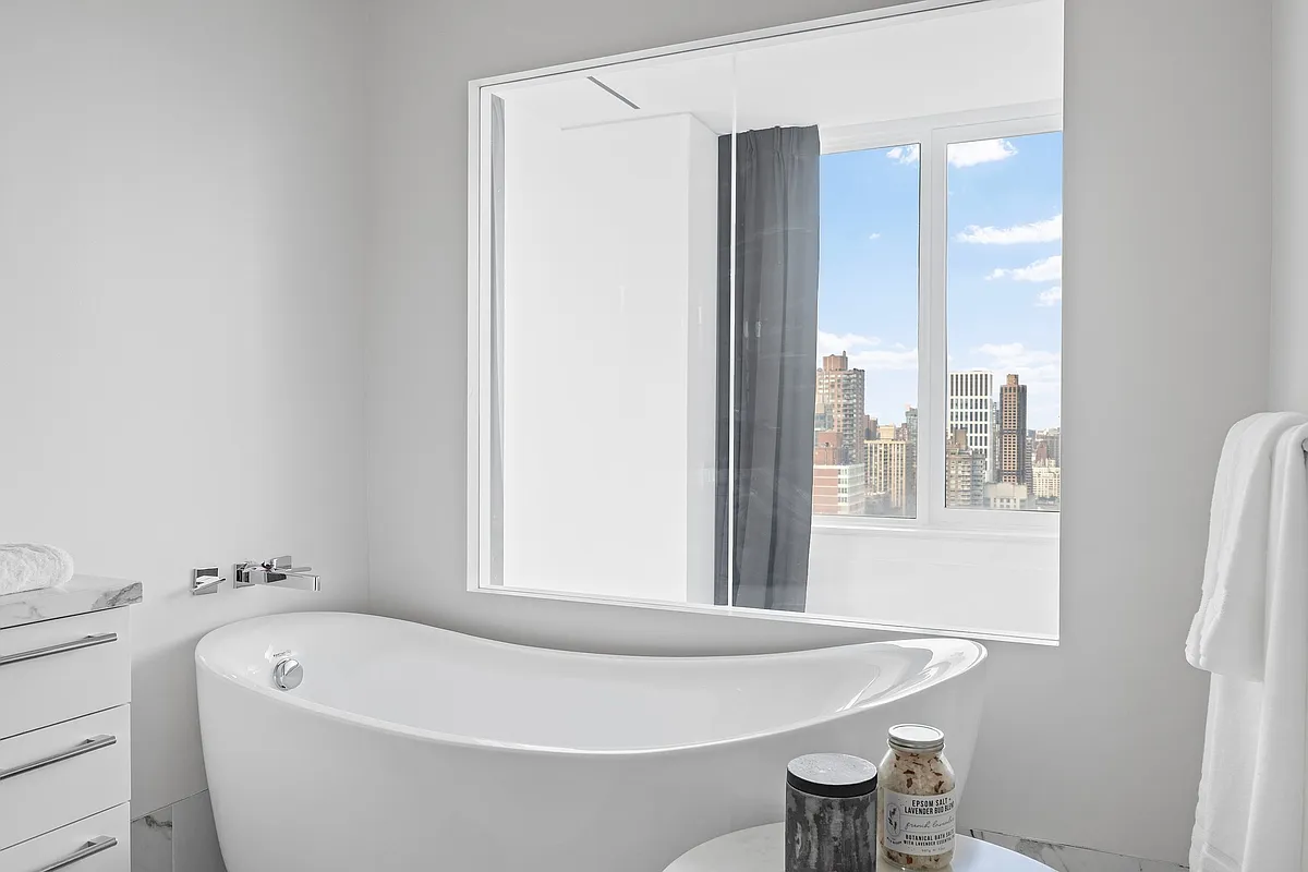 422 East 72nd Street, Unit 37AD Manhattan, NY 10021 - Photo 29 of 58 a white bath tub sitting next to a white sink