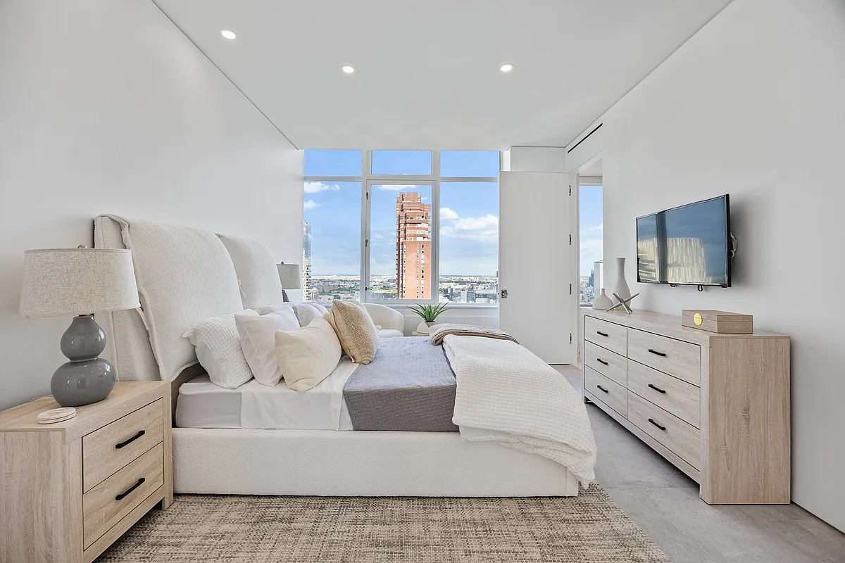 422 East 72nd Street, Unit 37AD Manhattan, NY 10021 - Photo 34 of 58 a living room with furniture a flat screen tv and a bathtub