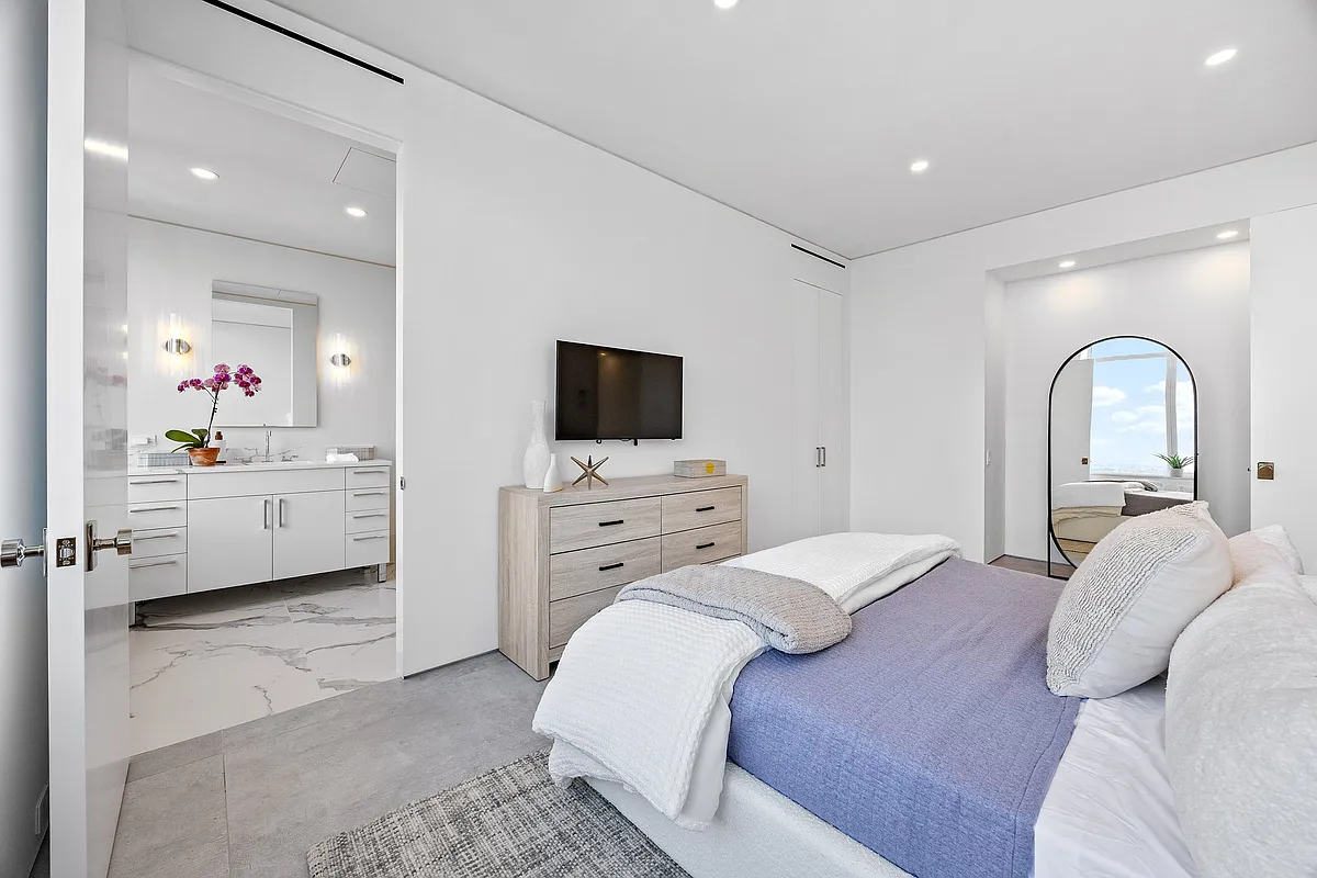 422 East 72nd Street, Unit 37AD Manhattan, NY 10021 - Photo 36 of 58 a bedroom with a bed and a flat screen tv
