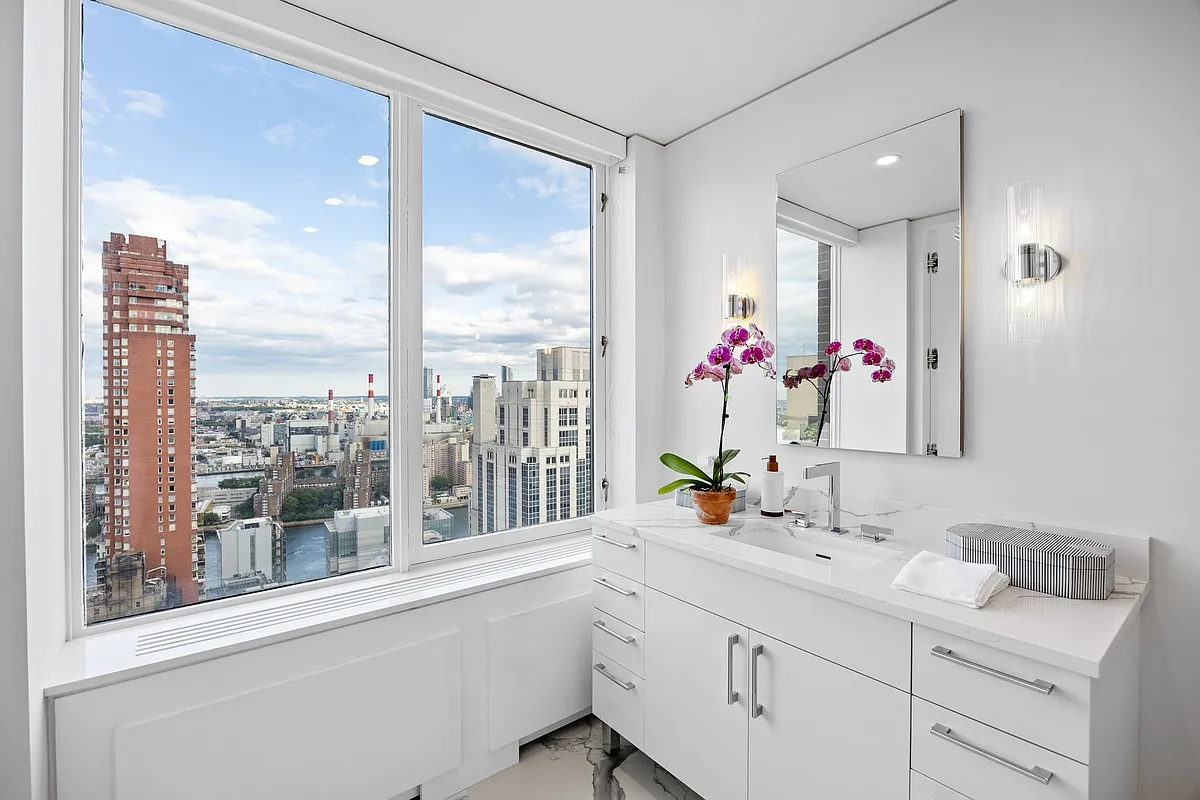 422 East 72nd Street, Unit 37AD Manhattan, NY 10021 - Photo 37 of 58 a bathroom with a sink mirror and a window