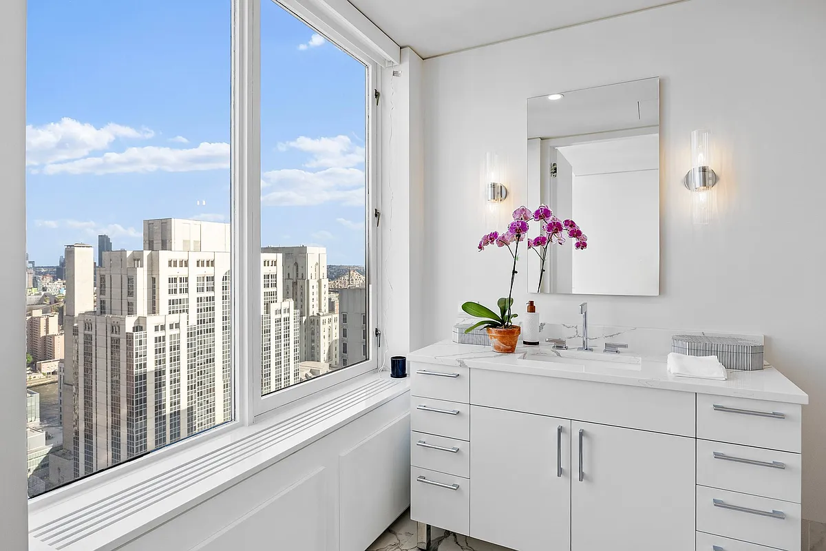 422 East 72nd Street, Unit 37AD Manhattan, NY 10021 - Photo 38 of 58 a bathroom with a sink double vanity and a shower