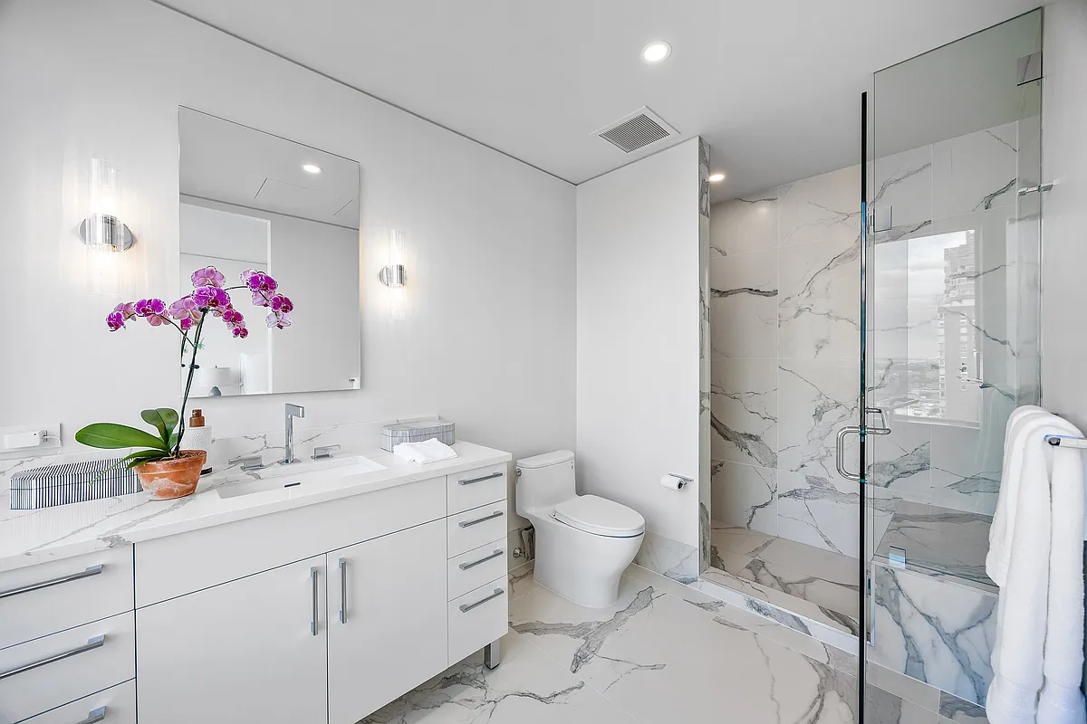 422 East 72nd Street, Unit 37AD Manhattan, NY 10021 - Photo 39 of 58 a bathroom with a sink vanity mirror and toilet