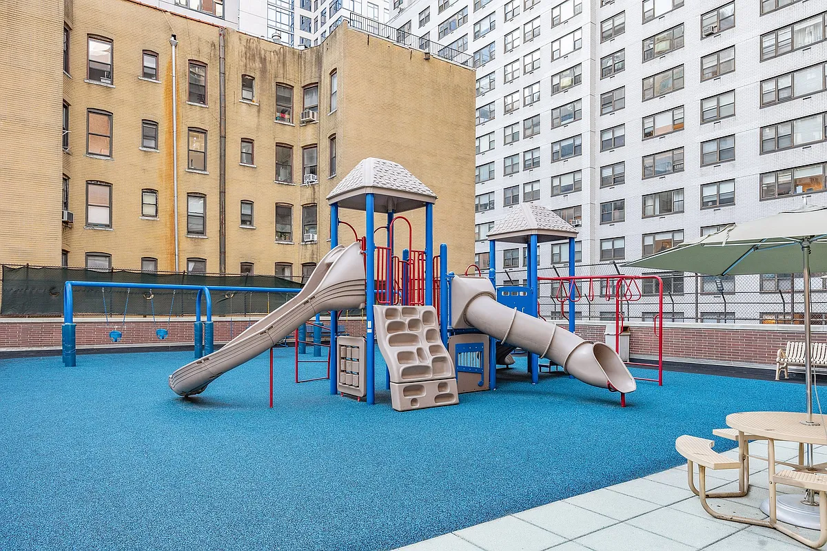 422 East 72nd Street, Unit 37AD Manhattan, NY 10021 - Photo 50 of 58 a living room with furniture and a floor to ceiling window