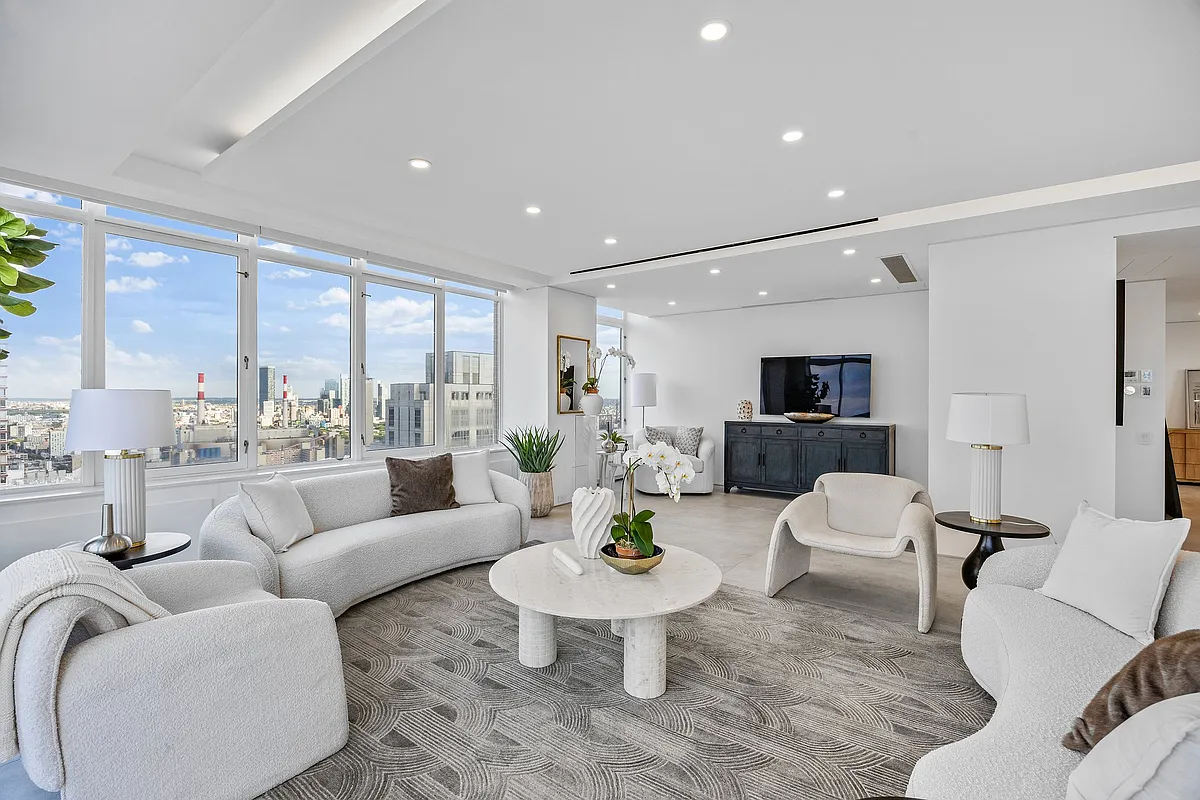 422 East 72nd Street, Unit 37AD Manhattan, NY 10021 - Photo 5 of 58 a living room with furniture and a large window