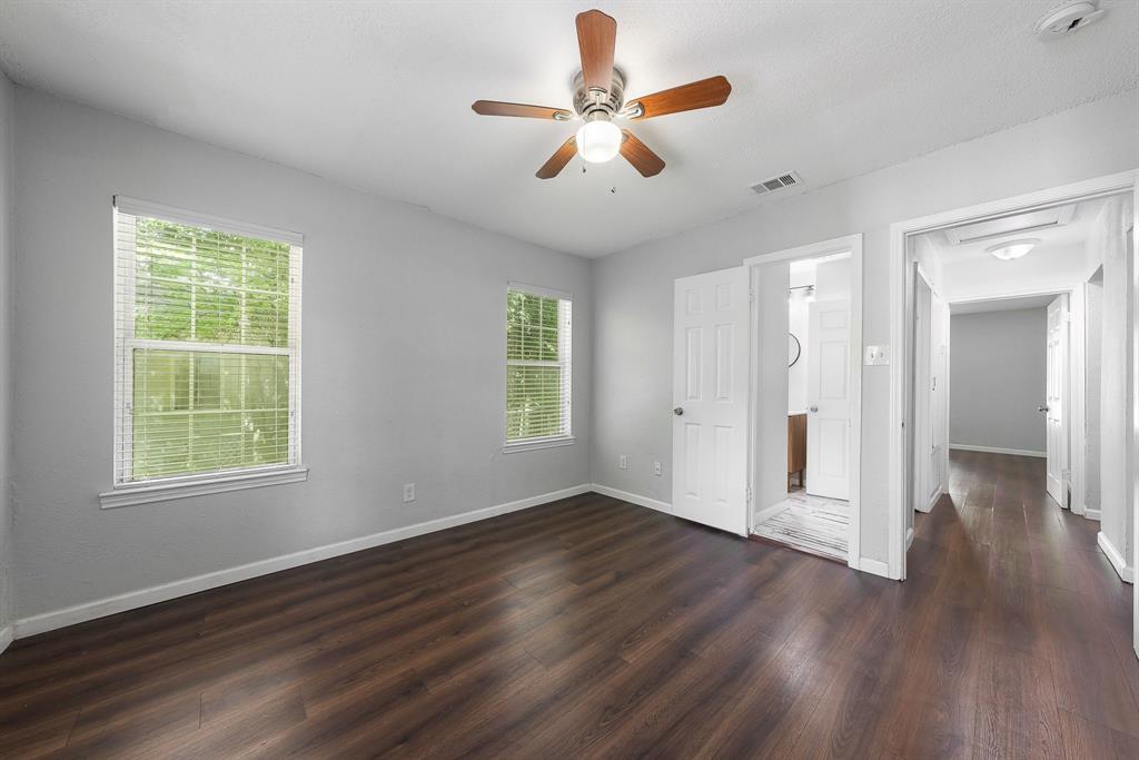 1330 Fordham Road Dallas, TX 75216 - Photo 20 of 37 Spacious interior room featuring wood-finish flooring, two windows with white blinds, and light grey wall paint
