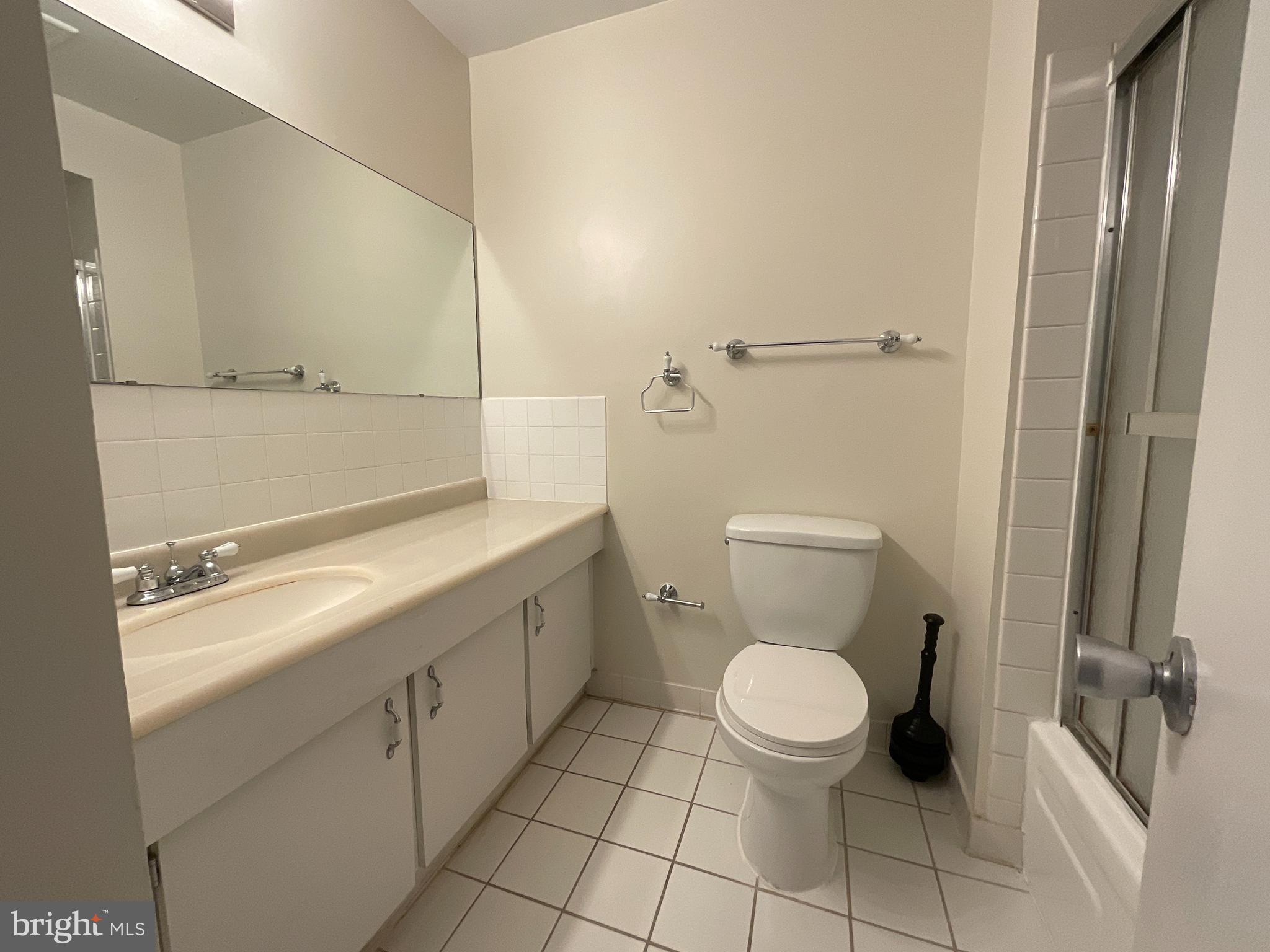 3024 Gentain Court Northeast, Unit 3024 Washington, DC 20017 - Photo 16 of 26 a bathroom with a toilet sink and a mirror