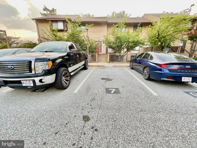 a view of a house with a balcony and floor to ceiling windows