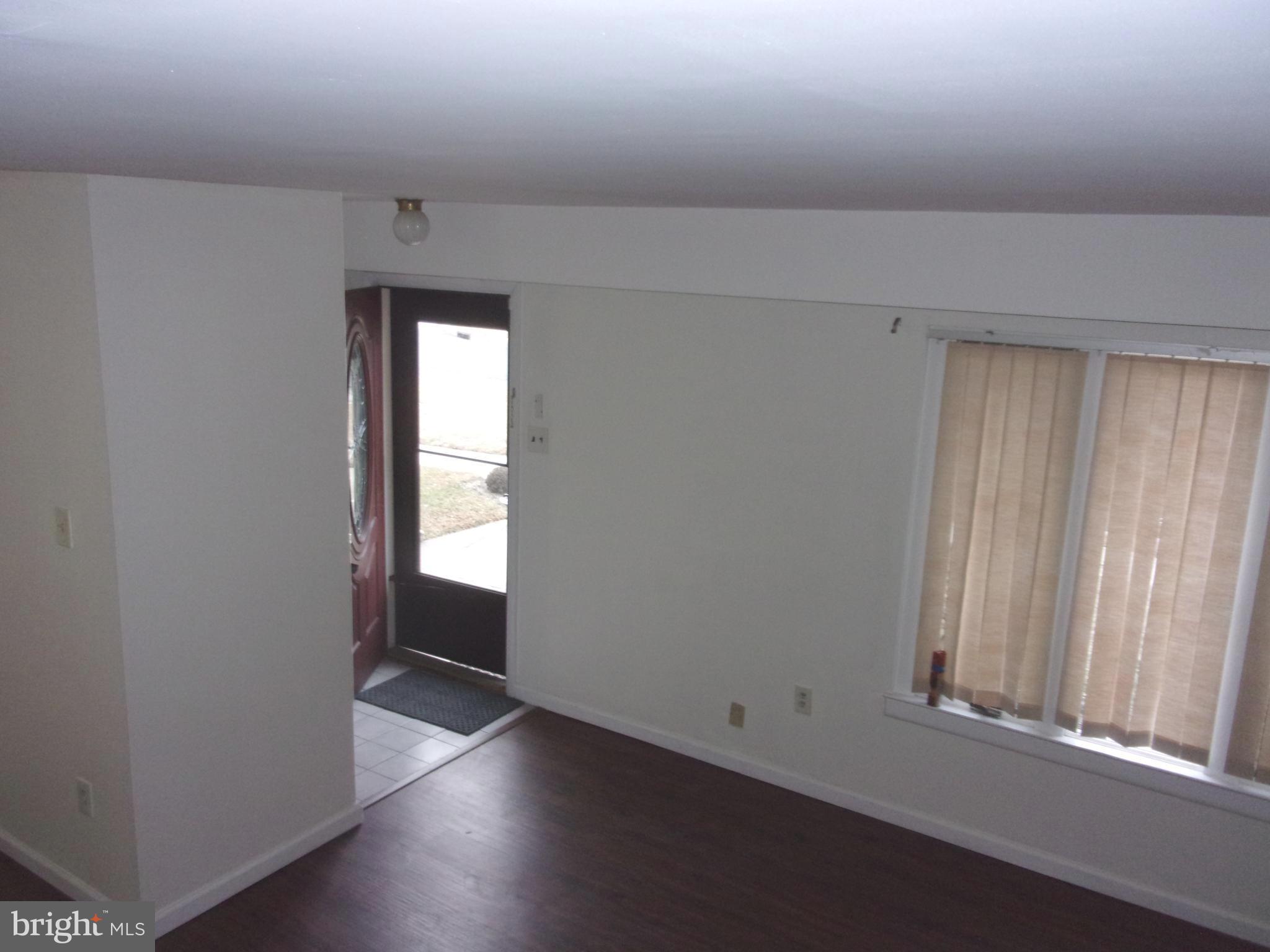 48 Chelsea Circle Clementon, NJ 08021 - Photo 6 of 15 an empty room with wooden floor and windows