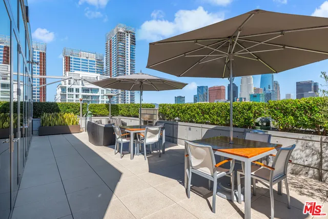 an outdoor space with furniture and umbrella