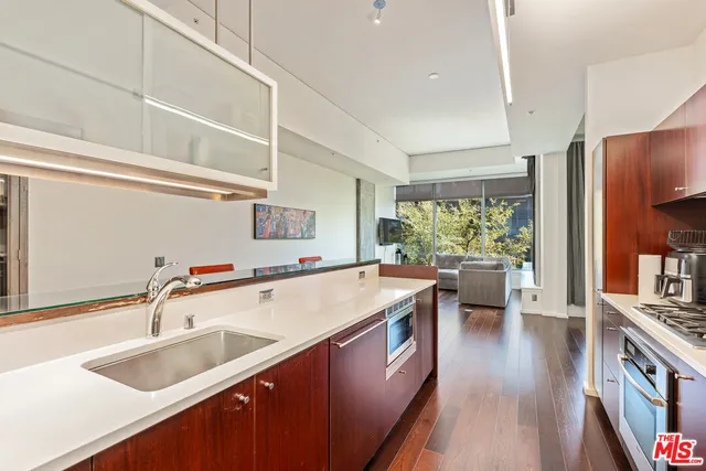a kitchen with a sink and wooden floor