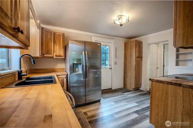 a kitchen with stainless steel appliances granite countertop a refrigerator and a sink