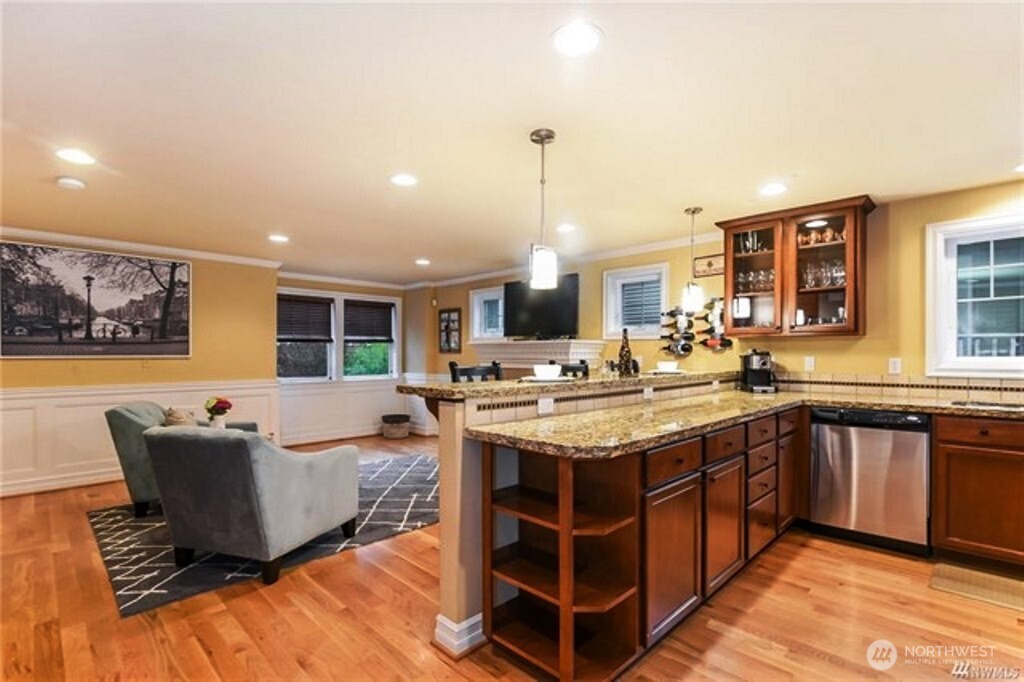 725 North 95th Street, Unit C Seattle, WA 98103 - Photo 2 of 18 a large kitchen with kitchen island a sink table and chairs