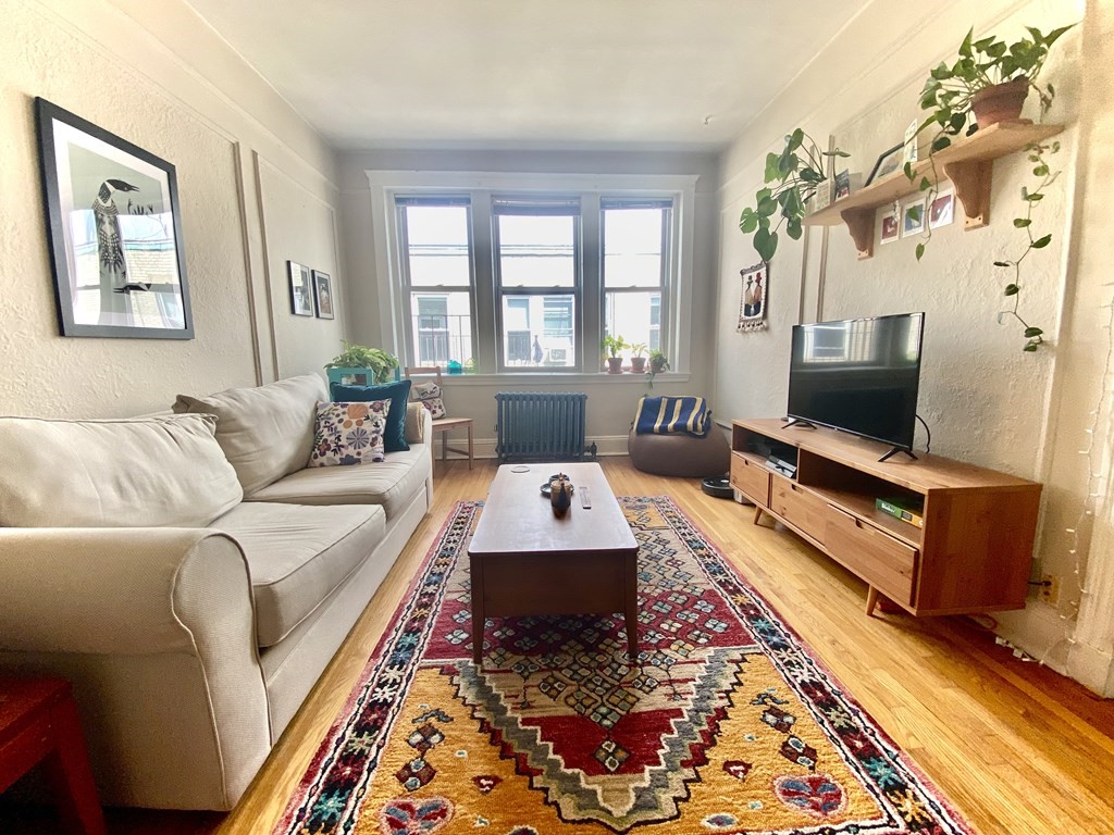 1691 Commonwealth Avenue, Unit 31 Boston, MA 02135 - Photo 1 of 12 a living room with furniture and a flat screen tv
