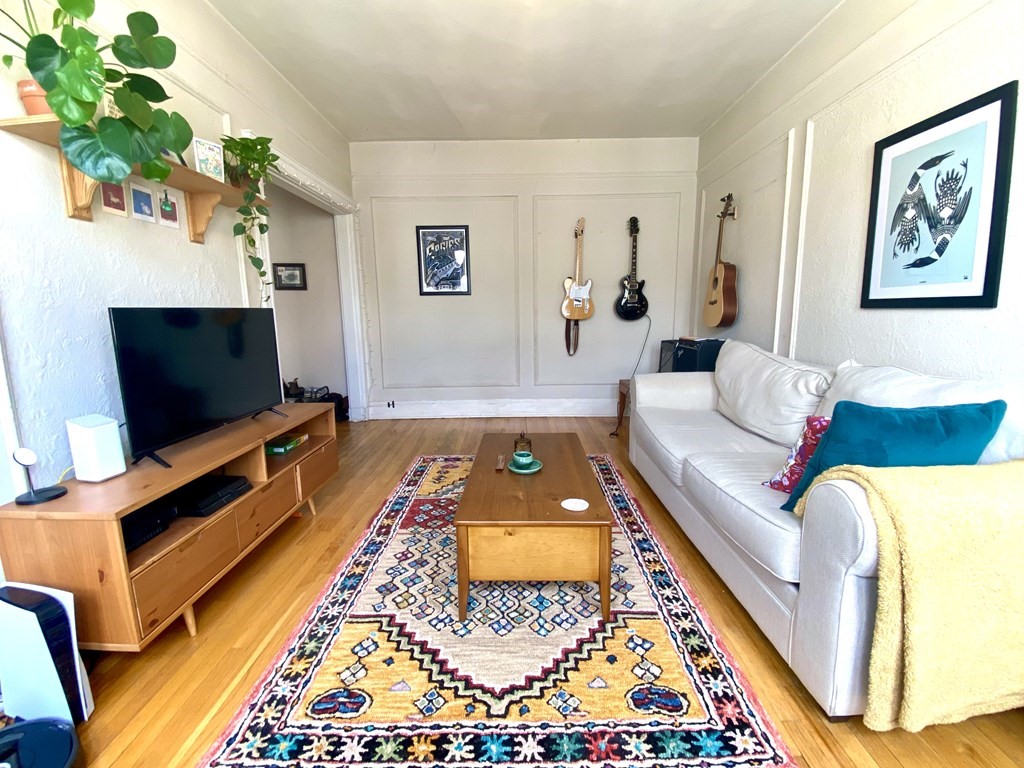 1691 Commonwealth Avenue, Unit 31 Boston, MA 02135 - Photo 2 of 12 a living room with furniture and a flat screen tv