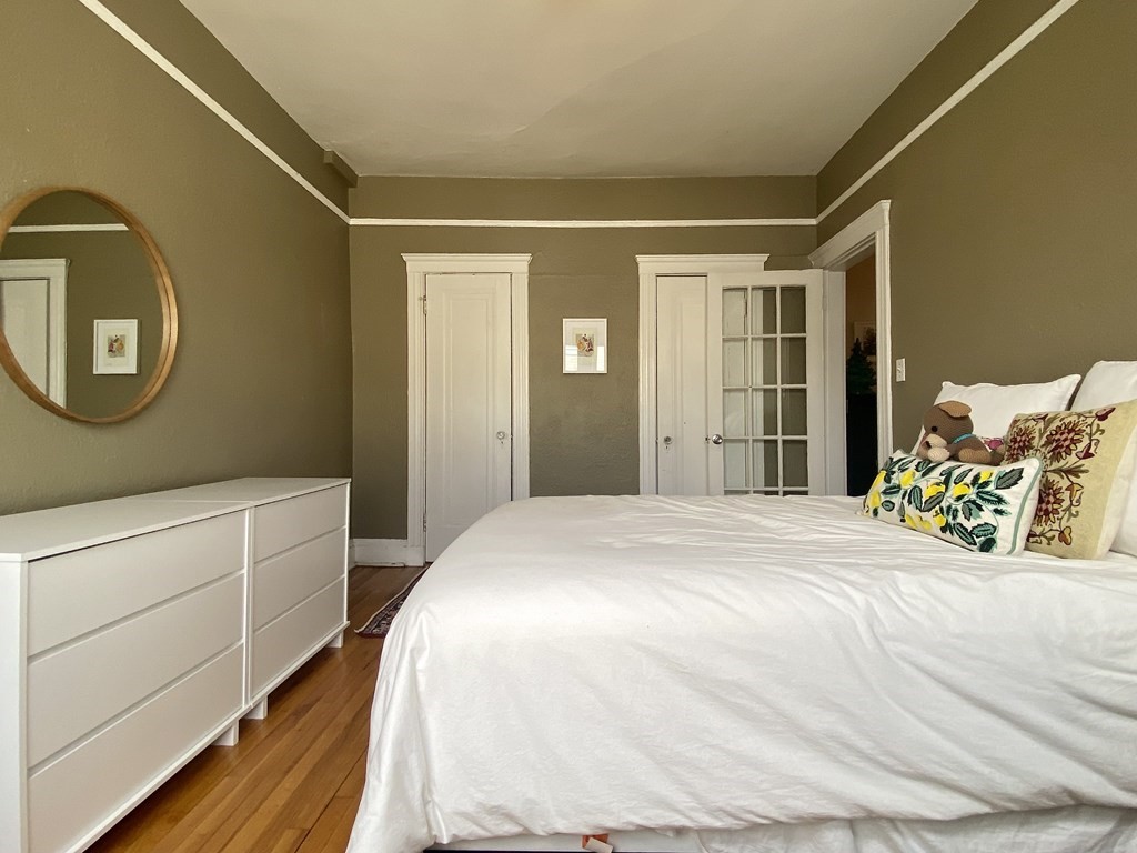 1691 Commonwealth Avenue, Unit 31 Boston, MA 02135 - Photo 5 of 12 a bedroom with a bed and a cabinets