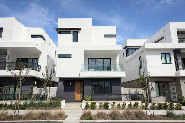 a kitchen that has a lot of cabinets a sink and wooden floor
