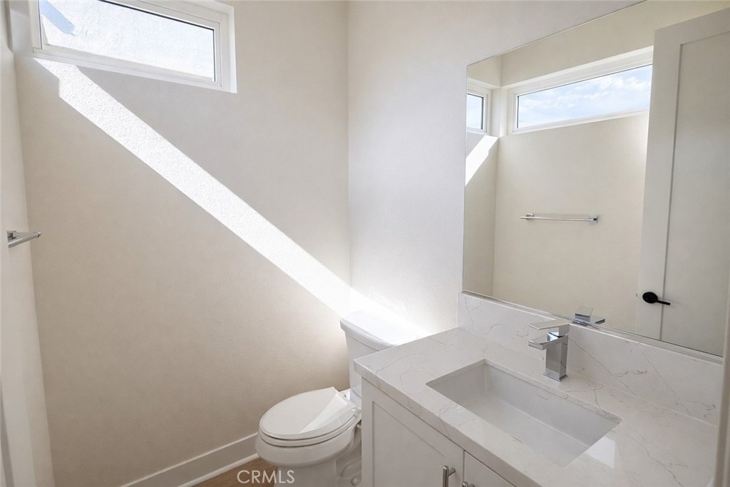 2173 Swaim Way Tustin, CA 92782 - Photo 14 of 34 a bathroom with a sink toilet and vanity