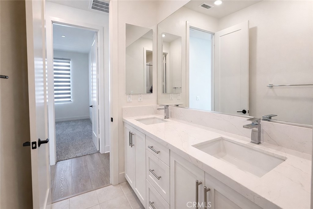 2173 Swaim Way Tustin, CA 92782 - Photo 16 of 34 a bathroom with a double vanity sink mirror and