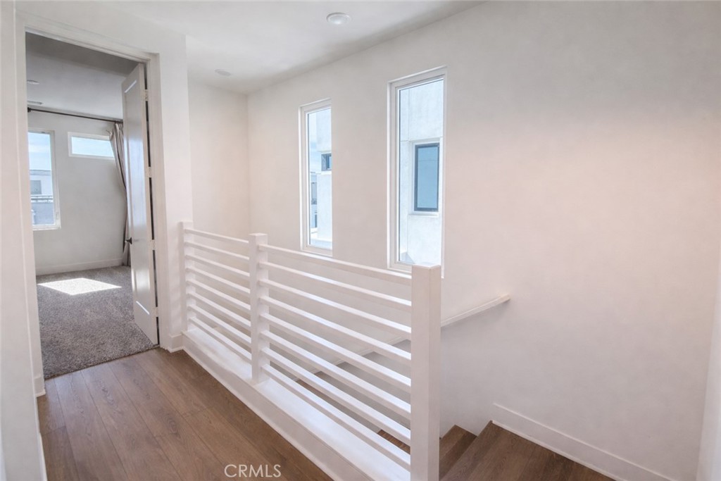 2173 Swaim Way Tustin, CA 92782 - Photo 17 of 34 a view of a bedroom with wooden floor and windows
