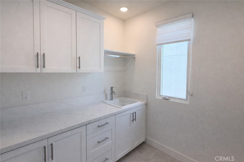 2173 Swaim Way Tustin, CA 92782 - Photo 23 of 34 a room with a sink cabinets and utility