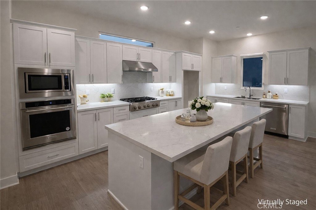 2173 Swaim Way Tustin, CA 92782 - Photo 10 of 34 a kitchen with a stove a sink and a refrigerator