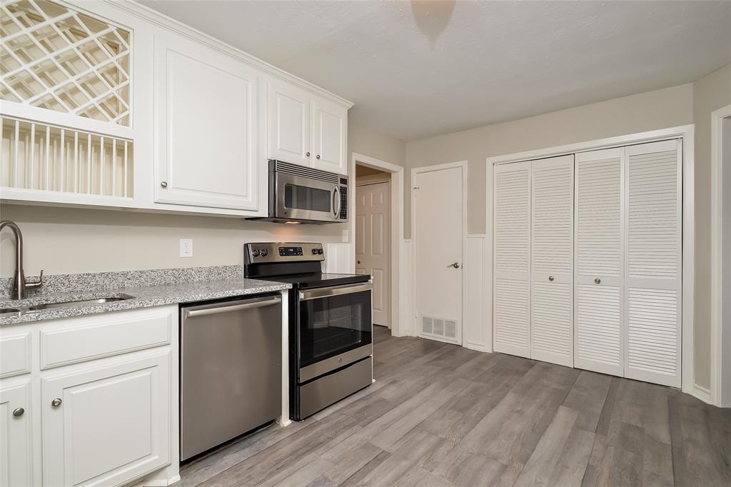 808 22nd Street Plano, TX 75074 - Photo 5 of 16 a kitchen with granite countertop a sink cabinets and stainless steel appliances