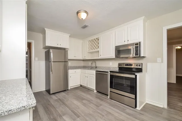 a kitchen with a sink a refrigerator and a stove
