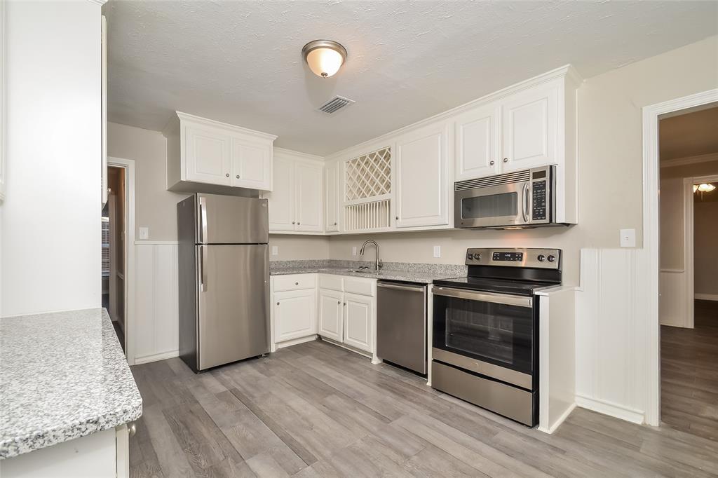 808 22nd Street Plano, TX 75074 - Photo 6 of 16 a kitchen with a sink a refrigerator and a stove
